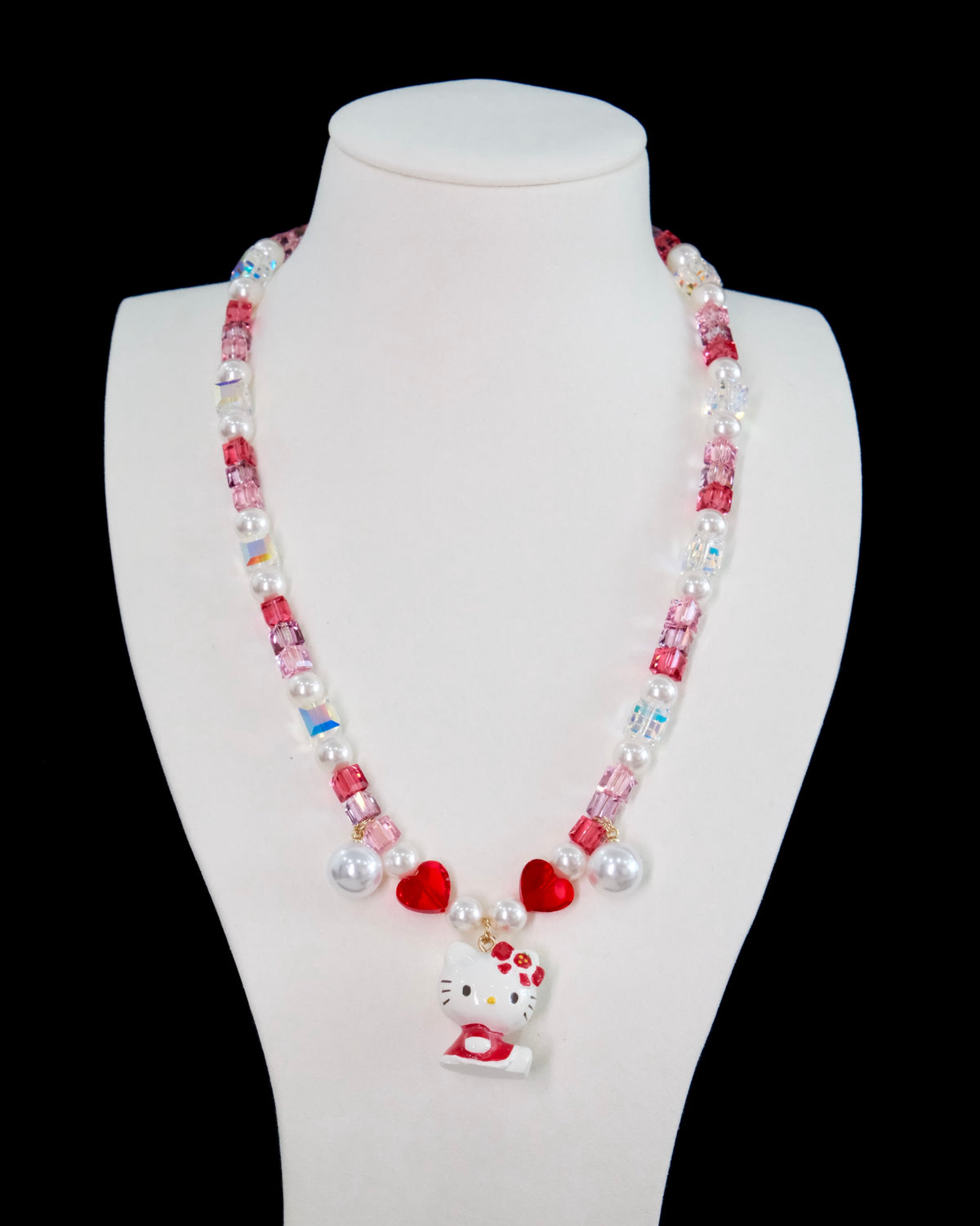 Close-up of a handmade Swarovski crystal charm necklace with crystals, pearls and sweetheart-inspired collectible charm details