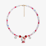 Close-up of a handmade Swarovski crystal charm necklace with crystals, pearls and sweetheart-inspired collectible charm details