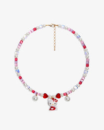Close-up of a handmade Swarovski crystal charm necklace with crystals, pearls and sweetheart-inspired collectible charm details