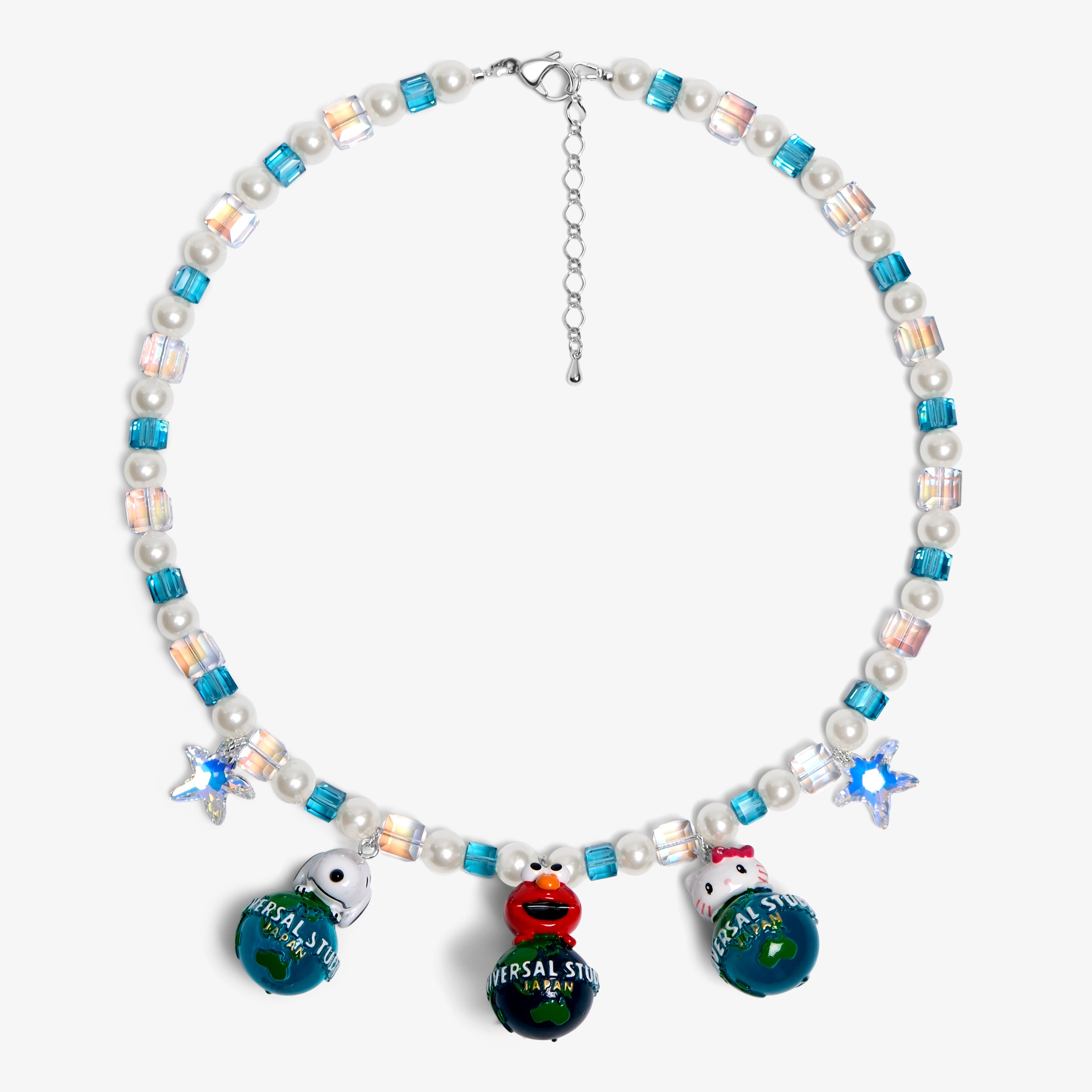 Close-up of a handmade Swarovski crystal charm necklace with crystals, pearls and travel-inspired collectible charm details