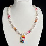 Model wearing a handmade Swarovski crystal charm necklace with crystals, pearls and western-inspired collectible charm details