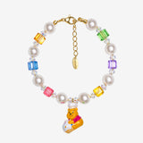 Rainbow Swarovski crystal cube and white crystal pearl bracelet with a yellow bear charm wearing a white chef hat.