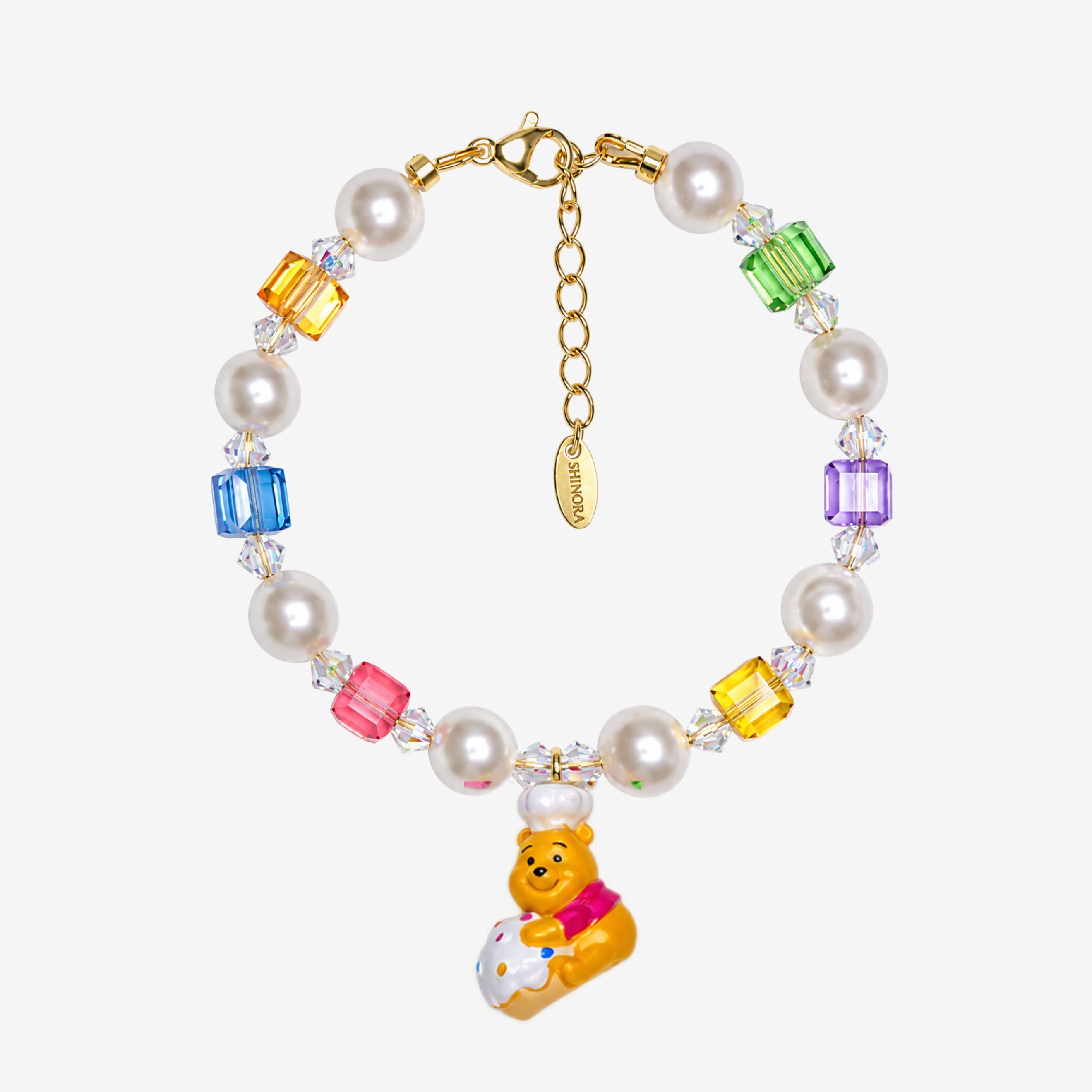 Rainbow Swarovski crystal cube and white crystal pearl bracelet with a yellow bear charm wearing a white chef hat.