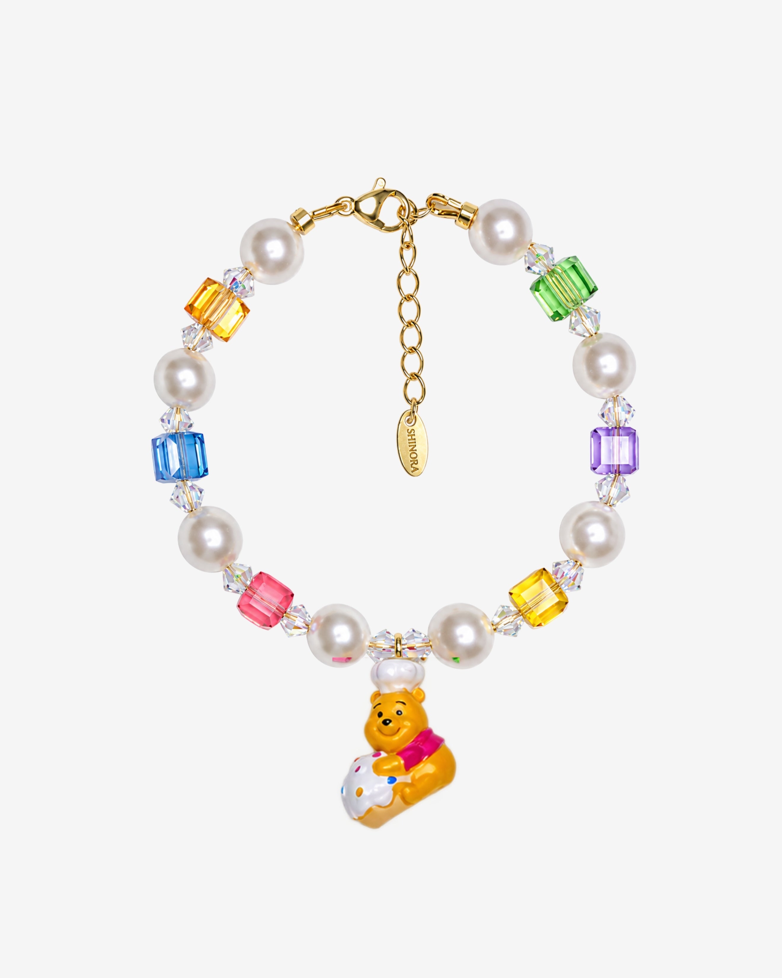 Rainbow Swarovski crystal cube and white crystal pearl bracelet with a yellow bear charm wearing a white chef hat.