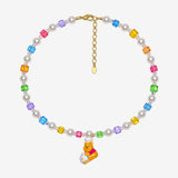 Rainbow Swarovski crystal cube and white crystal pearl necklace with a yellow bear charm wearing a white chef hat.