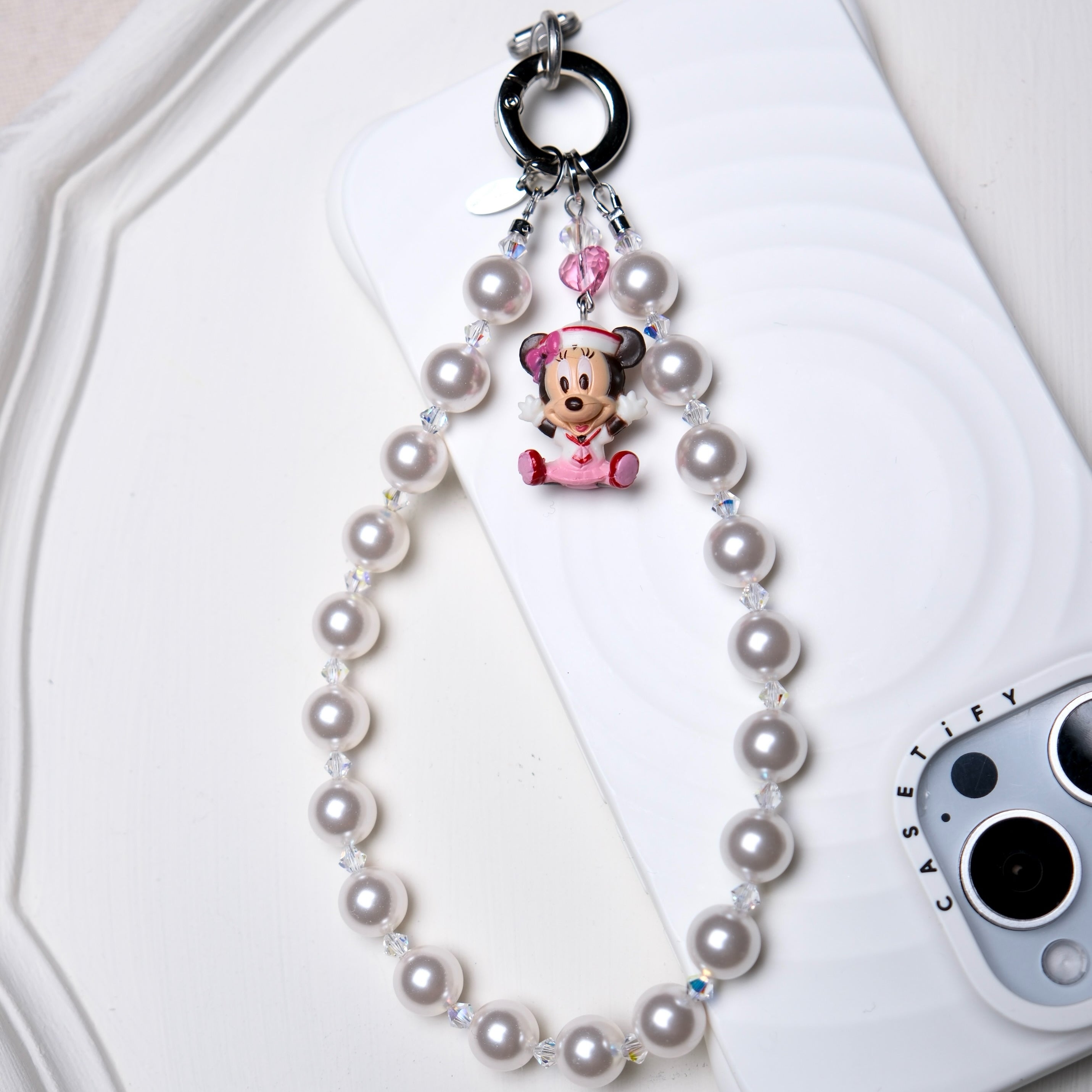 Product photo of a pink heart vintage character phone charm with pink and clear Swarovski crystal accents.