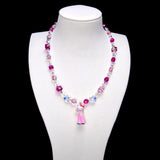 Pink crystal rounds and cubes alternate with clear iridescent beads. Clear star accents frame a Hello Kitty charm in pink trousers with blue shoes.