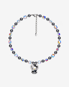 Necklace with dark gray Swarovski crystal pearls, iridescent crystal cubes and a cat charm in a black bonnet outfit with white trim.