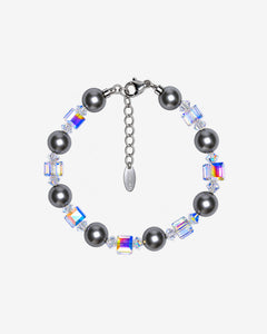 Bracelet with dark gray Swarovski crystal pearls, alternating iridescent crystal cubes, clear spacers and a silver-tone clasp.