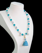 Model wearing handmade blue crystal charm necklace with silver Swarovski beads and pearls