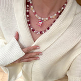 Gift-ready ShinoraStudio packaging for a handmade pink Swarovski crystal charm necklace with ski-inspired collectible charm details