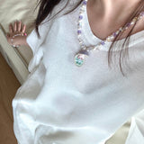 Gift-ready ShinoraStudio packaging for a handmade Swarovski crystal charm necklace with surf-inspired collectible charm details