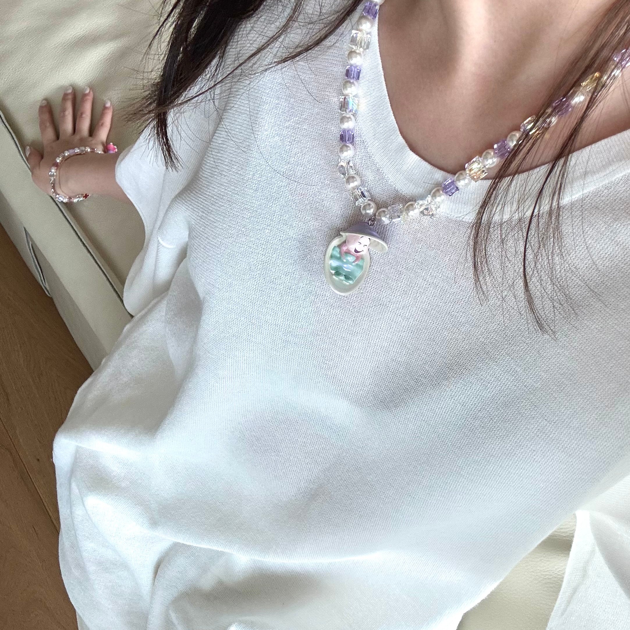 Gift-ready ShinoraStudio packaging for a handmade Swarovski crystal charm necklace with surf-inspired collectible charm details