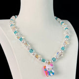 Gift-ready ShinoraStudio packaging for a handmade Swarovski crystal charm necklace with surf-inspired collectible charm details