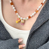 Gift-ready ShinoraStudio packaging for a handmade Swarovski crystal charm necklace with surf-inspired collectible charm details