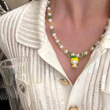 Gift-ready ShinoraStudio packaging for a handmade Swarovski crystal charm necklace with garden-inspired collectible charm details