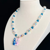 Gift-ready ShinoraStudio packaging for a handmade Swarovski crystal charm necklace with surf-inspired collectible charm details