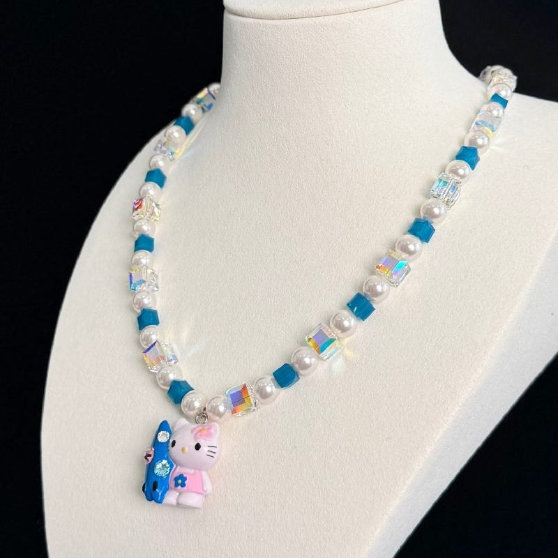 Gift-ready ShinoraStudio packaging for a handmade Swarovski crystal charm necklace with surf-inspired collectible charm details