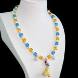 Gift-ready ShinoraStudio packaging for a handmade Swarovski crystal charm necklace with princess-inspired collectible charm details