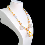 Gift-ready ShinoraStudio packaging for a handmade Swarovski crystal charm necklace with holiday-inspired collectible charm details