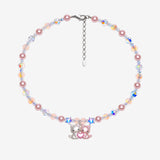 Necklace with pink Swarovski crystal pearls, peach and iridescent crystals, two stars and a pink-and-white cat duo pendant with a heart.